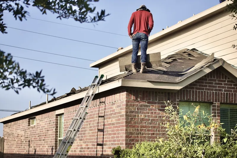 Professional roofer working on a residential roof in East Midtown